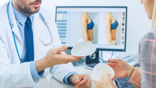 doctor holding breast implant