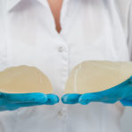 Plastic surgeon showing breast implants