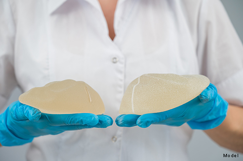 Plastic surgeon showing breast implants