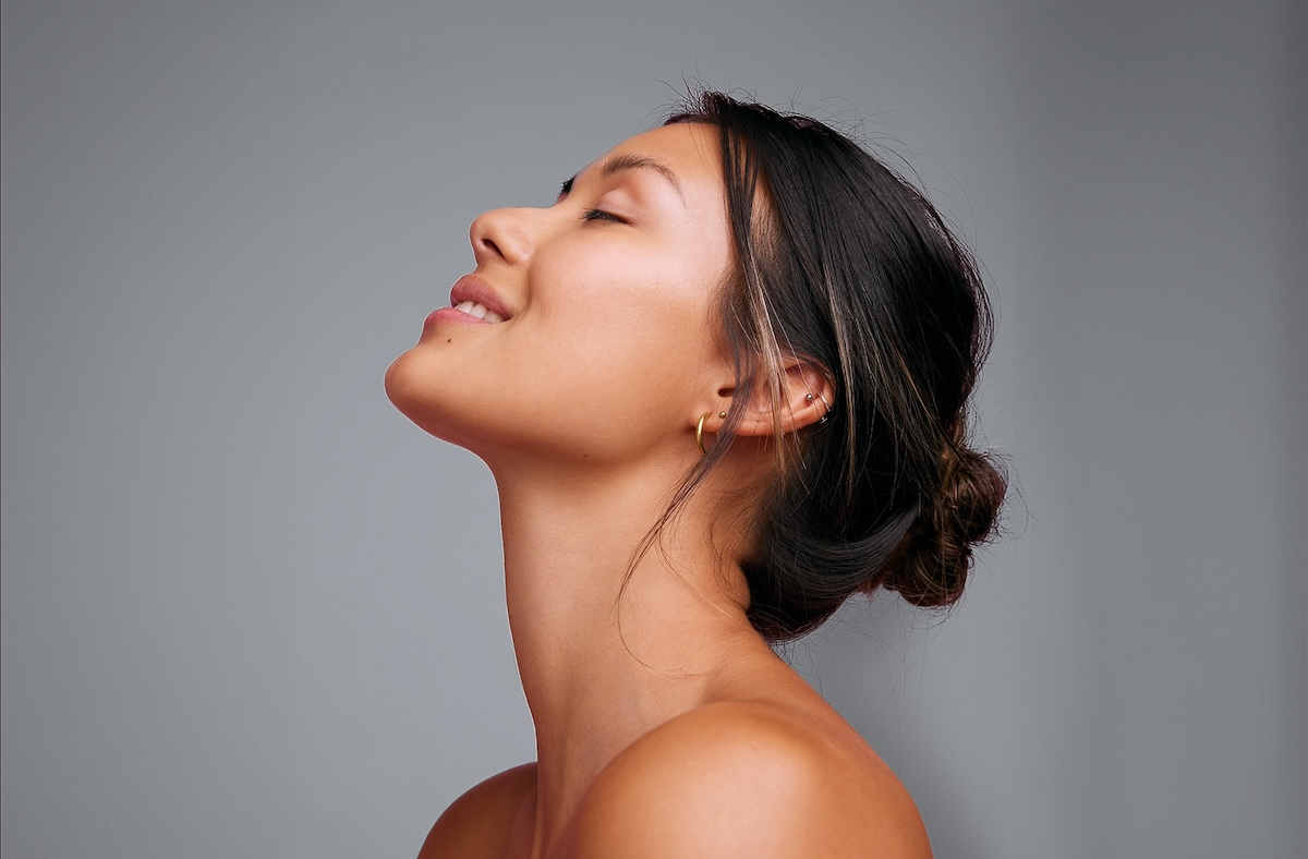 beautiful young woman with her eyes closed and head tilted back