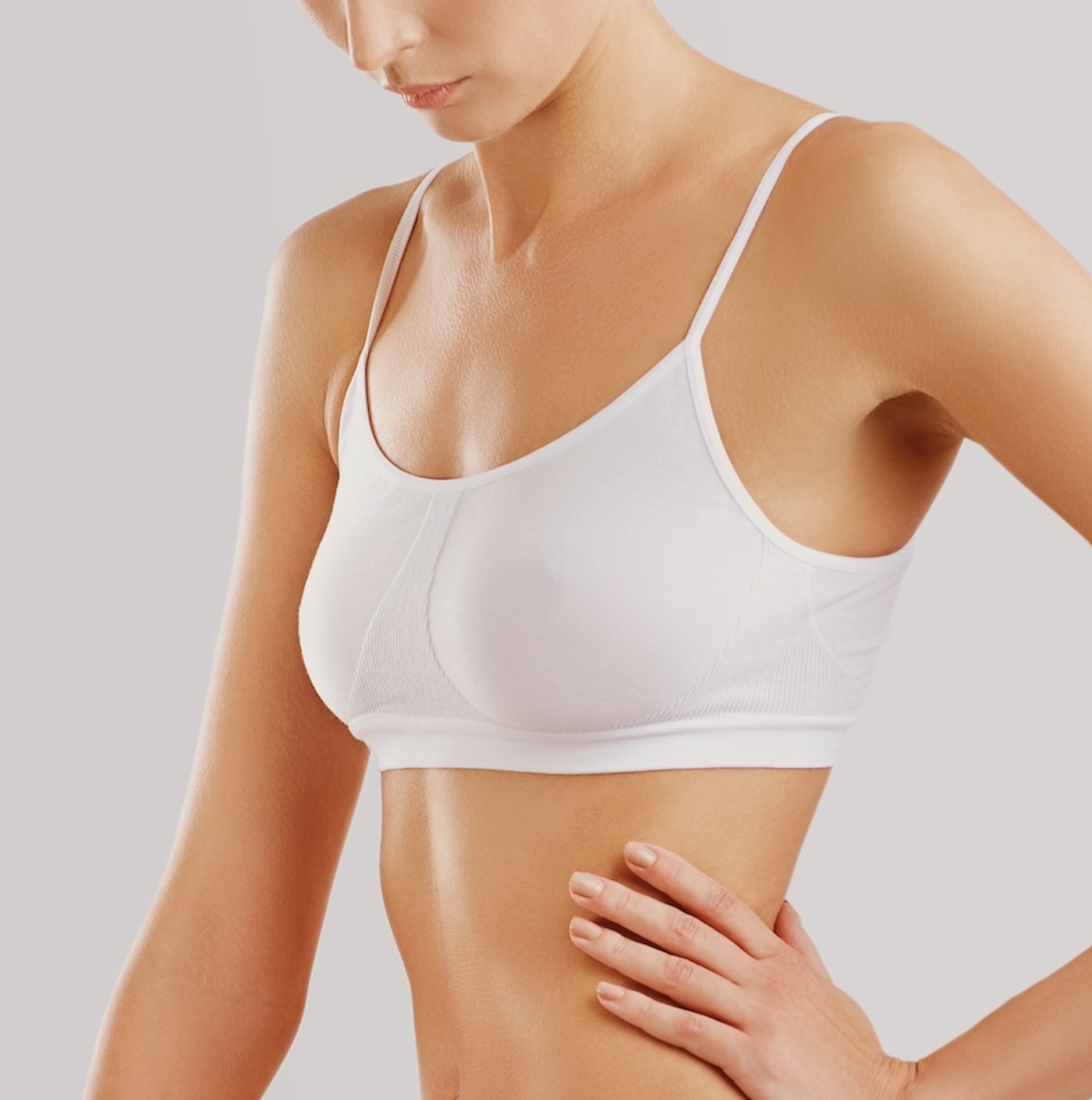 toned young woman in white bra and underwear