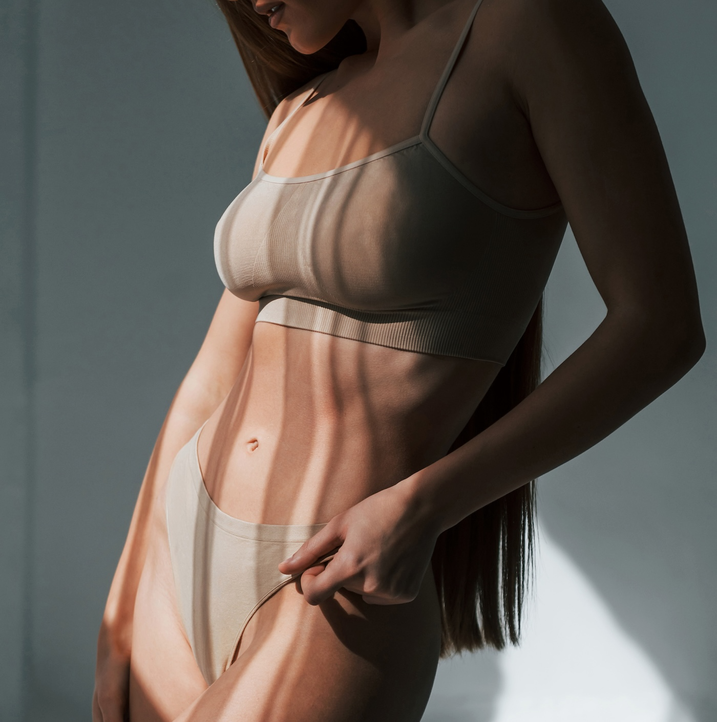 woman in nude bra and underwear standing up