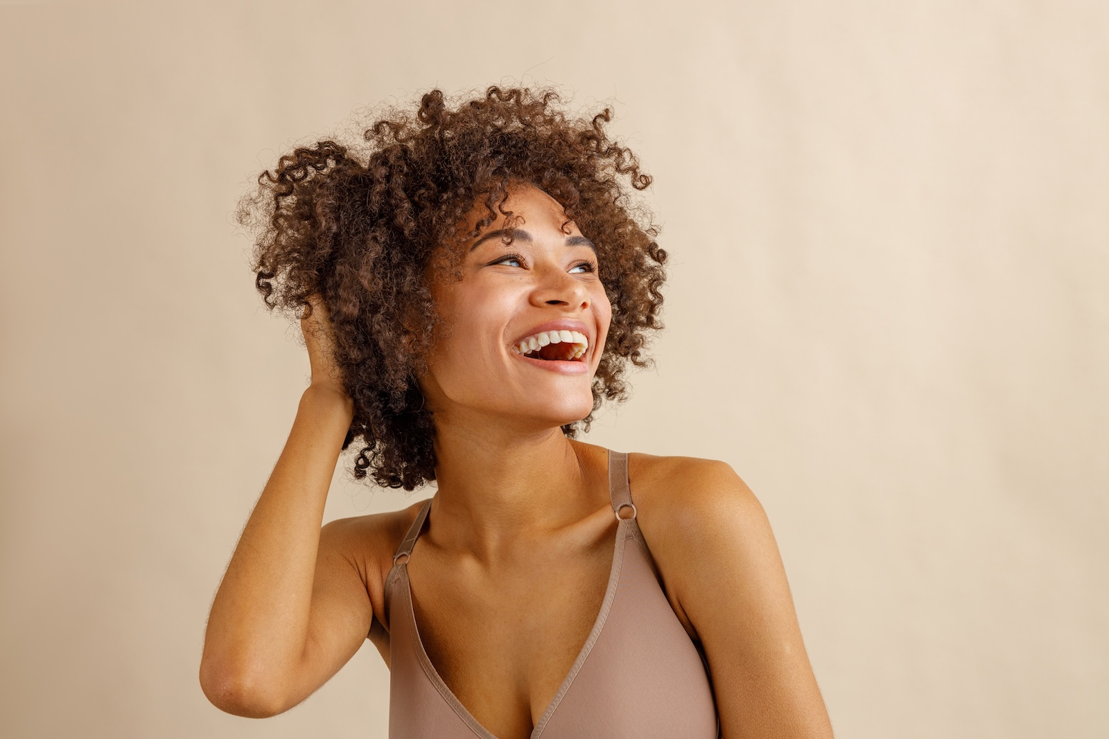 woman in nude bra laughing