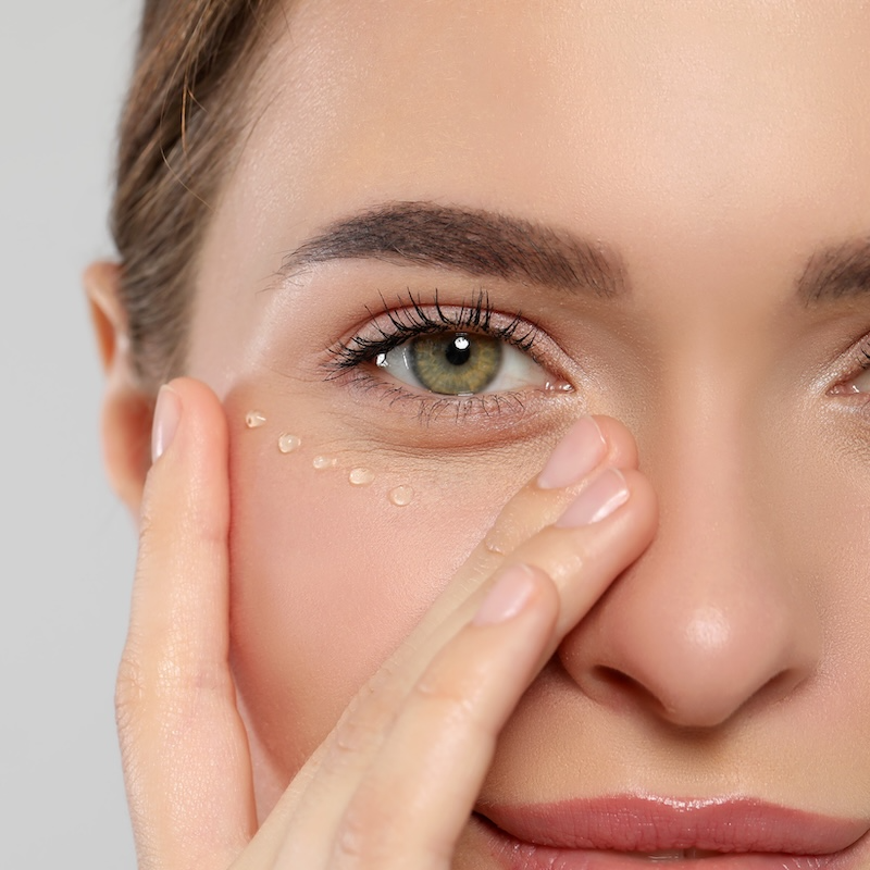 woman touching her eye